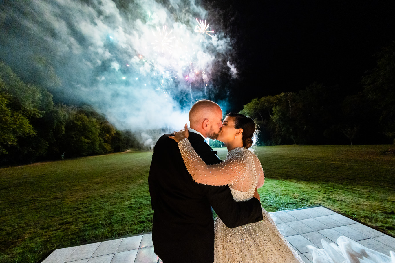 couple kissing under fireworks chateau challain wedding